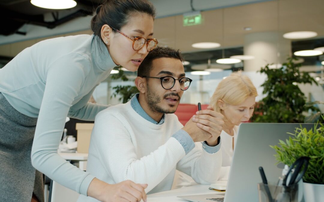 Two colleagues collaborating on a computer screen