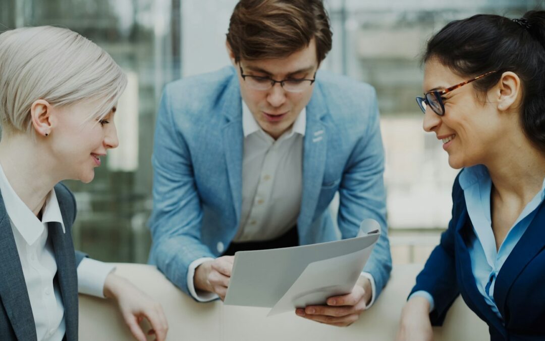 Three professionals discussing a document together