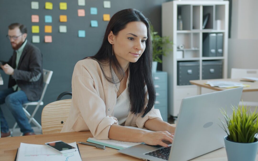 Woman working on laptop in a modern office